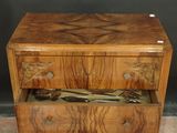 a wooden chest of drawers with a pair of scissors in it