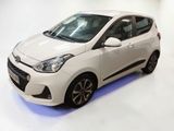 the white car is parked on the white floor in the room