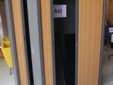 a metal and wood locker with a sign on the door
