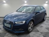 the blue audi is parked in a garage with a checkered floor