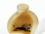 a small glass vase with a black and white design on it