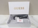 guess socks in a box on a table with a tag on it