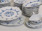 a lot of blue and white plates and cups and saucers