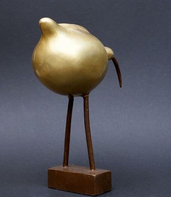 bronze sculpture of a bird on a wooden base
