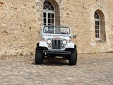 a white jeep that is parked in front of a building