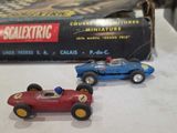 two toy cars sitting next to each other on a table