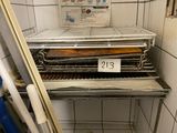 a metal rack with a tray of food on top of it