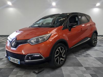 a red car is parked on a checkered floor in a garage