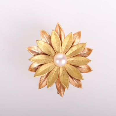 gold tone flower brooch with a pearl center