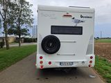 an image of a white rv parked on the side of the road