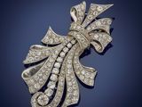 a diamond and gold broochle, by van cleef