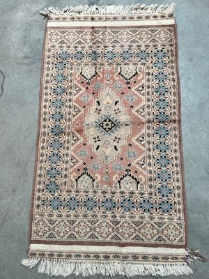 an old rug with fringes and fringes on the ground