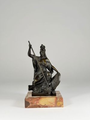 a bronze statue of a woman holding a spear and a fish