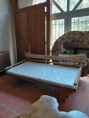 a bed that is in a room with a fireplace in the background