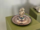 a silver plate with a lion on top of it