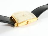 a watch that is sitting on top of a black leather strap
