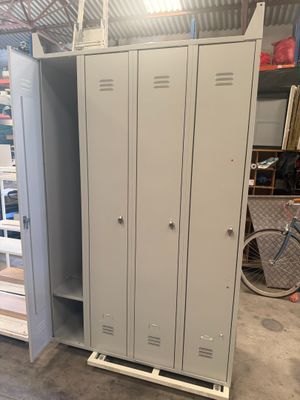 two lockers in a garage with a bike in the background