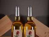 two bottles of wine sitting next to each other on a table