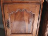 a wooden cabinet with a mirror on top of it