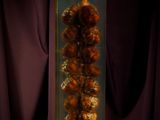 an image of a glass vase filled with gold balls