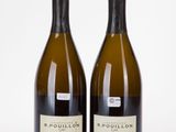 two bottles of wine sitting next to each other on a white surface