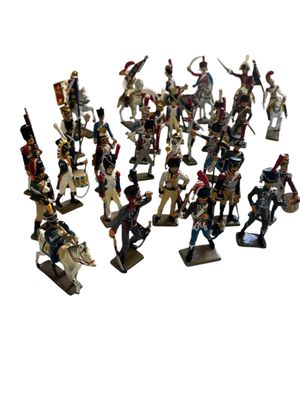 a lot of figurines that are on a white surface