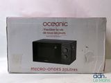 packaging of a microwave oven sitting on top of a white table