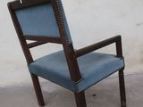 a blue chair that is sitting on the sidewalk