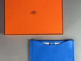 an orange and blue box and a blue wallet sitting next to each other