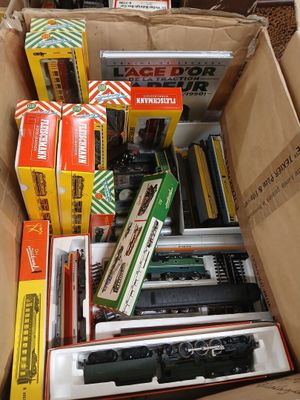 a box full of different types of toy trains in it
