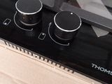 a black stove top with two burners on top of it