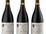 three bottles of red wine sitting next to each other on a white surface