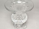 a clear glass bowl on a stand on a table