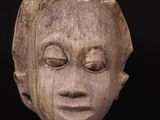 an image of a wooden sculpture of a woman ' s face