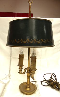 a lamp that is sitting on a table with a lamp shade on it