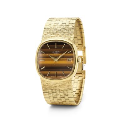 un gros plan d'une montre-bracelet en or avec un cadran en œil-de-tigre