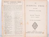 an old book opened to a page with a picture of a frog on it