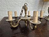 a chandelier that is on a table with a lamp