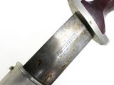 a close up of a knife on a white surface