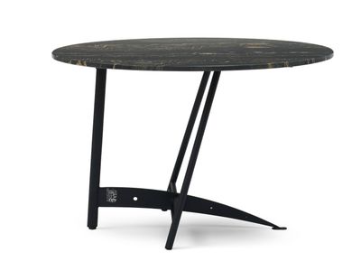 a round table with a black marble top and metal legs
