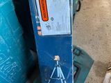 a box with a picture of a man standing on a tripod