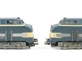two blue trains on a white background one is blue and the other is yellow