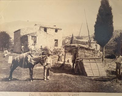 a black and white photo of a man standing next to a horse