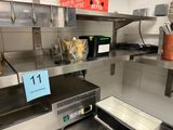 stainless steel counter top in a commercial kitchen with a microwave and toaster