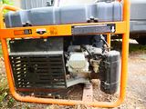 an orange and black generator sitting on the ground