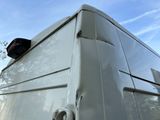 a white van that is parked on the side of the road