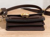 a close up of a brown leather purse with a gold buckle