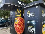 two boxes with pizzas painted on them on the side of the street