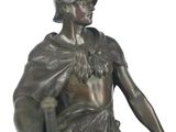 bronze statue of a man holding a bird on his shoulder