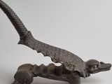bronze figurine of a dragon on a white background